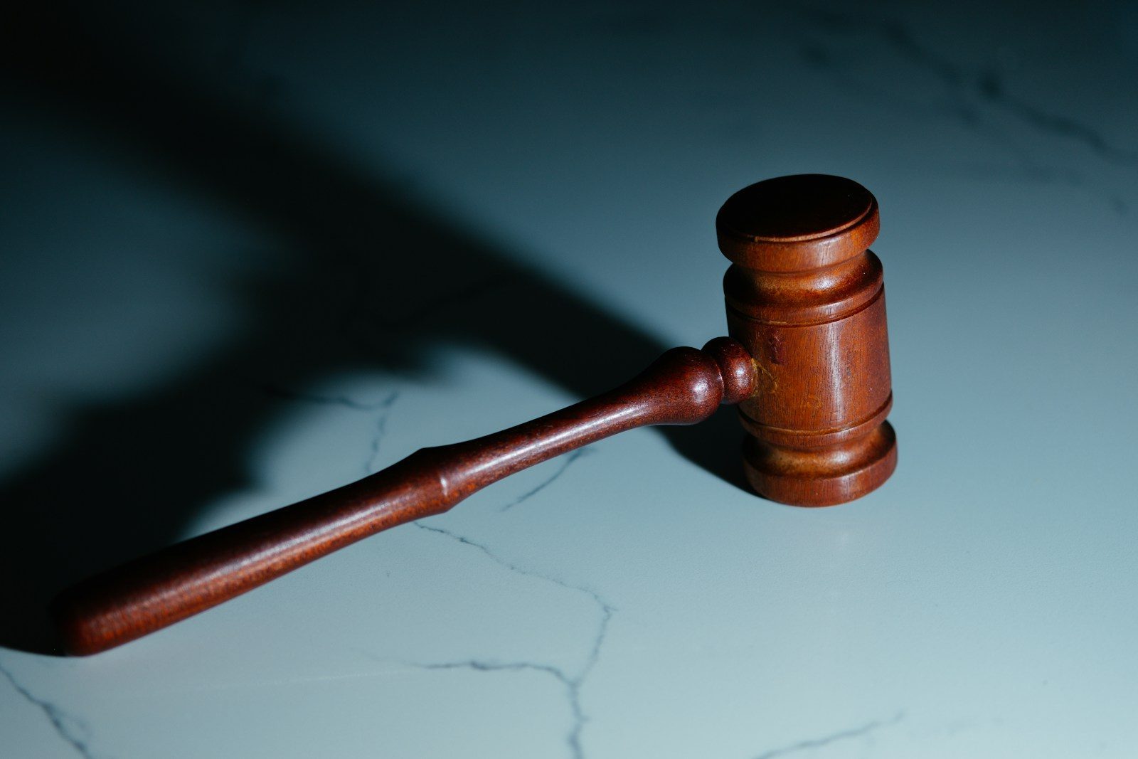 a wooden judge's hammer sitting on top of a table